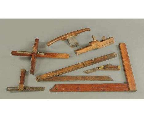 A collection of antique woodworking tools, T-square, spoke shave, etc. 