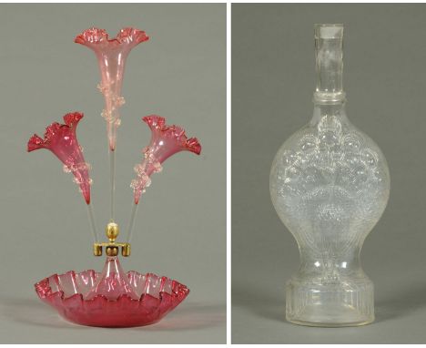 A Victorian three branch cranberry glass epergne, two cut glass decanters and an American peacock moulded flask.     CONDITIO