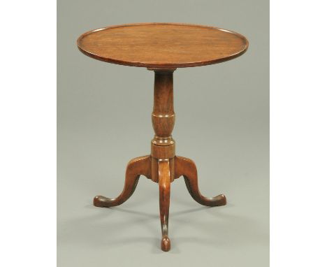 A George III mahogany tripod table, with dished top, turned column and three downswept legs terminating in pad feet.  Diamete