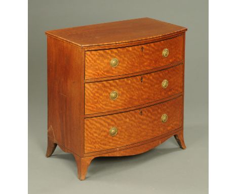 A George III mahogany bowfronted chest of drawers, ebony strung, three drawers with brass drop handles with octagonal backpla