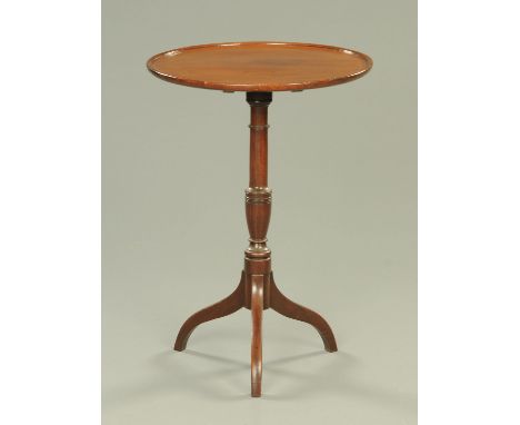 An early 19th century mahogany tripod table, circular, with snap action, turned column and three downswept legs.  Diameter 51