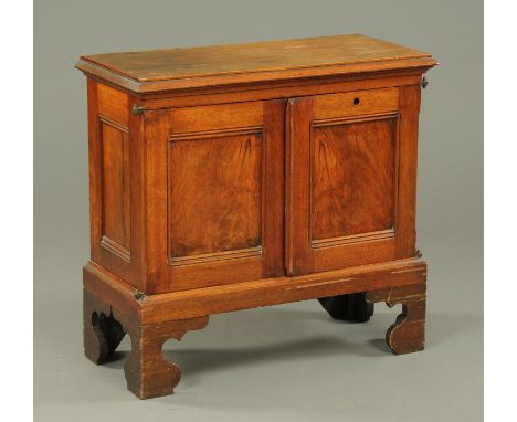 An Edwardian walnut office cupboard, with moulded edge above a pair of doors and raised on bracket feet.  Width 77 cm. 