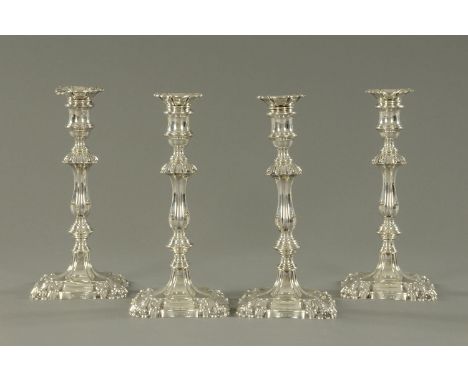 A set of four Edwardian silver candlesticks, Messrs. Carrington, London 1903/4, with detachable foliate moulded sconces, urn 