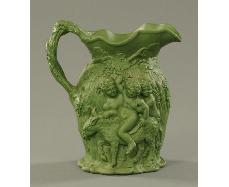 A Minton jade green Drunken Silenus relief moulded jug, 19th century, with applied sprig mark to the underside and impressed 