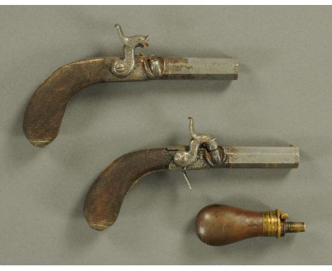 A pair of H. Cogswell Strand London pocket pistols, with turn off barrels, folding trigger guards and checkered walnut stocks