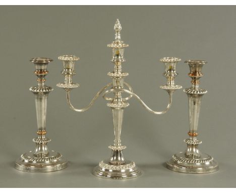 A silver plated two branch candelabra, and a pair of Sheffield plate candlesticks.  Tallest 40 cm. 