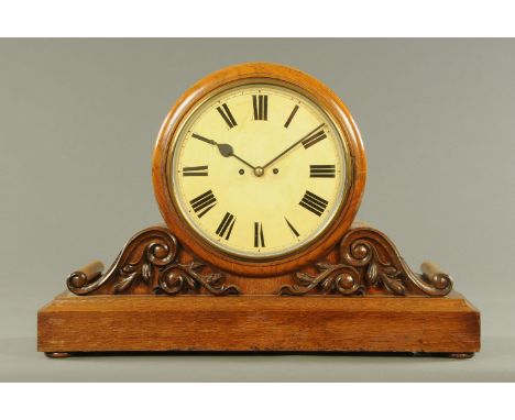 A large late Victorian oak office mantle clock, with two-train fusee movement, the face with Roman numerals, the case with ap