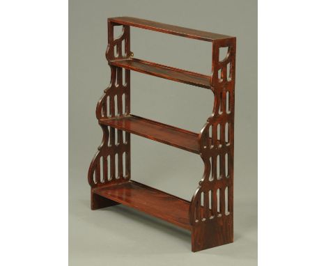 An Edwardian mahogany open wall mounting shelf unit, with fretwork sides.  Width 66 cm. 