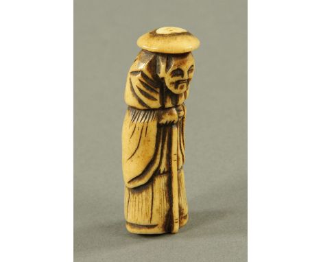 A Chinese carved bone netsuke, 19th century, carved as an elderly figure with walking cane and wide brimmed hat.  5.5 cm.