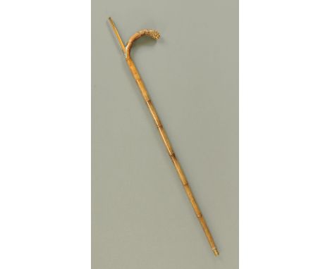 A Victorian walking stick, with integral 5' boxwood rule.  Length 93 cm. 