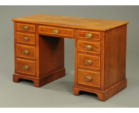 A late 19th century Sheraton Revival kneehole desk, with satinwood banded, boxwood and ebony strung drawer fronts all with br