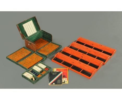 A mah-jong set, early 20th century, with bone sticks, black and caramel celluloid tiles, all in a tooled leather case with gr