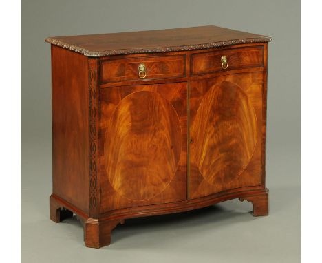 A George III style serpentine fronted mahogany side cabinet, crossbanded and with carved edge above two frieze drawers and pa