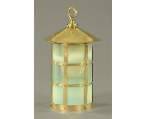 An Arts & Crafts brass hanging light shade, circa 1900, with a cylindrical Vaseline glass sleeve within a brass cage and with