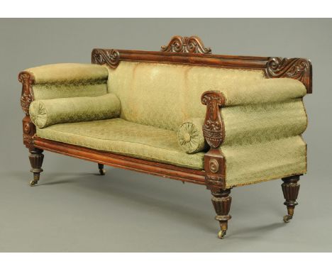A William IV rosewood sofa, with bolster ends and exposed carved showframe raised on lobed and turned front legs.  Width 204 