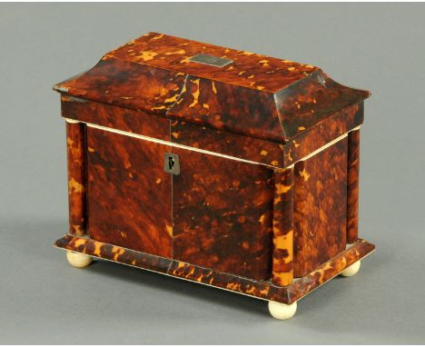 A 19th century tortoiseshell tea caddy, rectangular, with pillars to each corner, two interior compartments and raised on fou