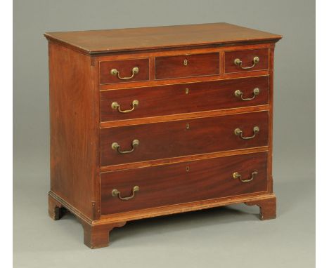 A Georgian mahogany chest of drawers, with moulded edge above three short and three long drawers with brass drop handles with