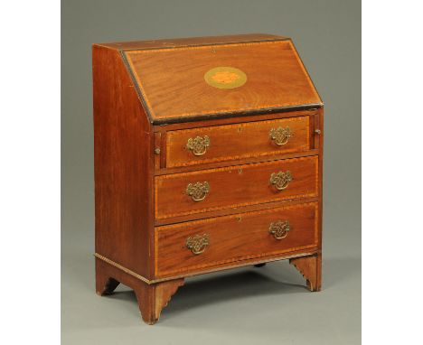 An Edwardian inlaid mahogany bureau, with shell to flap and raised on bracket feet.  Width 76 cm. 