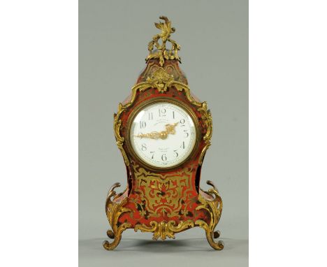 A French boulle marquetry mantle clock, with single-train movement, "Examined by John Barker & Co. Ltd., Kensington, London".
