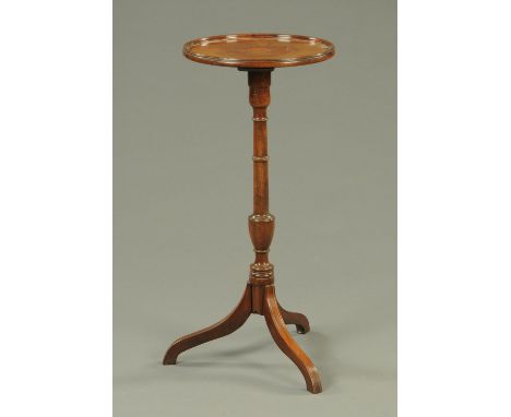 A 19th century mahogany tripod table, with moulded lip, turned column and three downswept boxwood strung legs.  Diameter 34.5