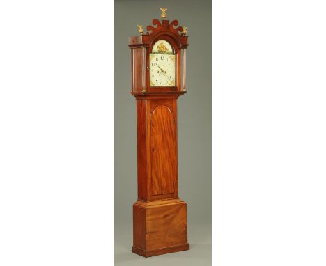 An early 19th century mahogany longcase clock, with fretwork pediment above an arched glazed door enclosing the painted dial 