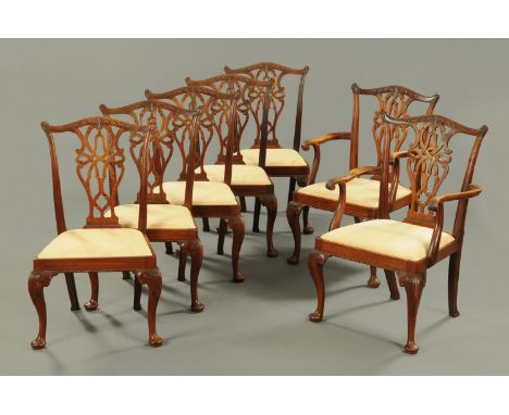 A set of seven Chippendale style dining chairs, comprising two arm and five single, each with yoke shaped top rail, pierced s