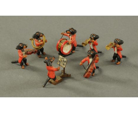 A novelty cold painted orchestra, 20th century, modelled as dachshunds playing a multitude of instruments with conductor (7).