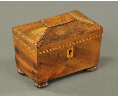 A mahogany miniature tea caddy, mid 19th century, with boxwood stringing and escutcheon, the lid opening to reveal two lidded