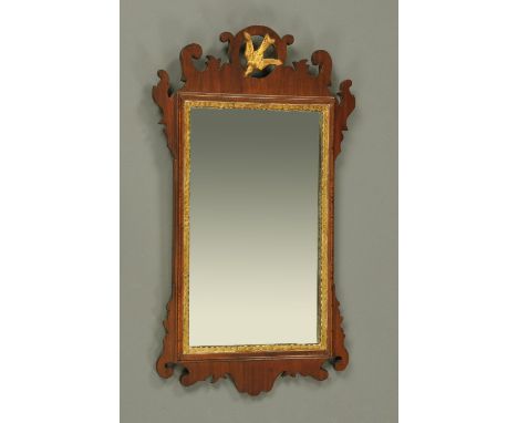 A 19th century mahogany Chippendale style fretwork wall mirror, with gilt swallow pediment.  Height 66 cm, width 39 cm. 