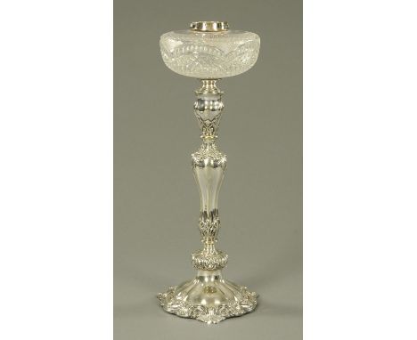 A good silver plated oil lamp, late 19th century, with a cut glass reservoir above a foliate and scroll relief decorated colu