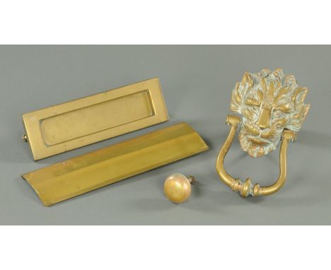 A cast brass door knocker, 19th century, cast in the form of a lion mask with lyre shaped knocker, the lion mask 15 cm x 12.5