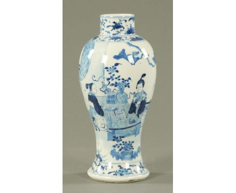 A Chinese blue and white inverted baluster vase, 19th century, painted with ladies playing go with attendants holding either 