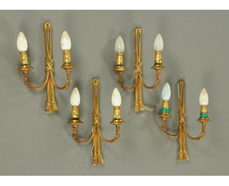 Four gilt brass twin branch wall light fittings.  Height 32 cm. 