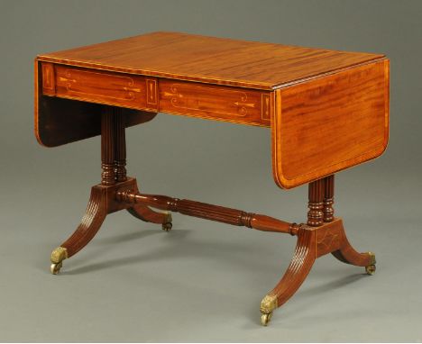 A Regency satinwood crossbanded and inlaid sofa table, each flap with rounded corners and fitted with two frieze drawers, rai