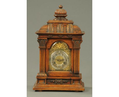 A late 19th century walnut mantle clock, with two-train Junghans movement striking on a single gong.  Height 51 cm. 