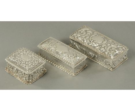 Three English silver hallmarked trinket boxes, late 19th/early 20th century, each decorated with C scrolls, with vacant carto