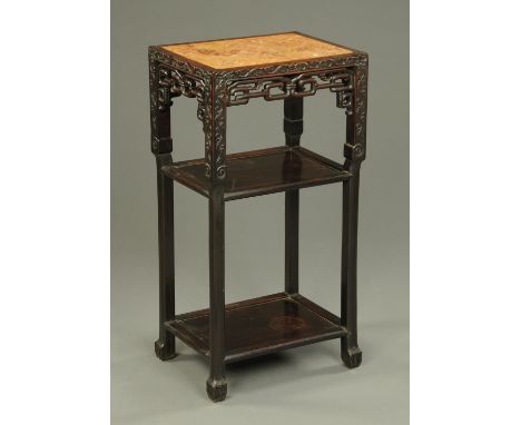A late 19th century Chinese hardwood stand, with rouge marble top and two open shelves.  Width 42 cm (see illustration).    C