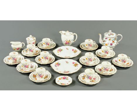 A Royal Crown Derby tea service, teapot, sugar basin, milk jug, 12 cups, 12 saucers, 6 sandwiches plates.