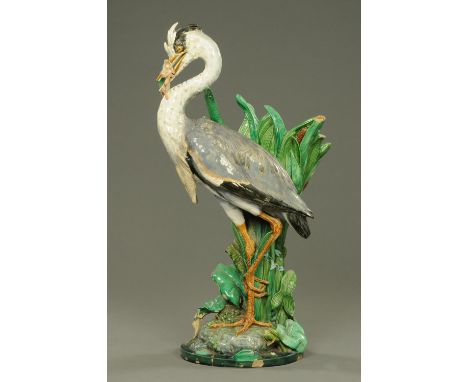 An impressive Minton Majolica stick stand, date code for 1876, modelled by Paul Comolera, a heron with wriggling fish in its 