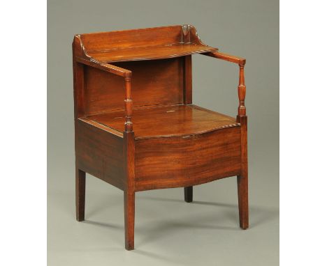 A George III mahogany serpentine fronted commode, with rear hinged shelf and raised on tapered legs of square section, furnis