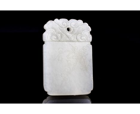 Age: Qing Dynasty    Description: A very fine white jade plaque carved with undulating scroll patterns at the top surrounding