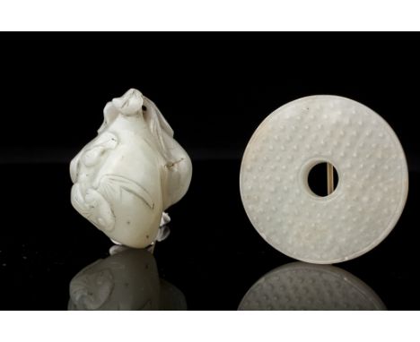 Date: Qing dynasty  Description: A finely carved Chinese white nephrite jade bi disk with delicately carved 'grain' pattern o