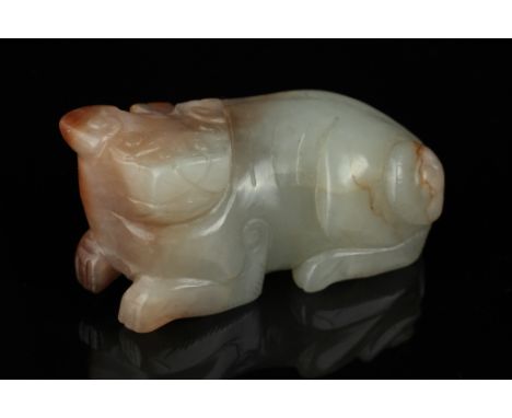 Date: Ming dynasty    Description: A Chinese jade mythical beast in a recumbent pose from a mottled stone of celadon and russ