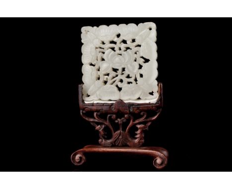 Date: Qing dynasty    Description: A Chinese white nephrite jade reticulated square plaque decorated with a peony blossom scr