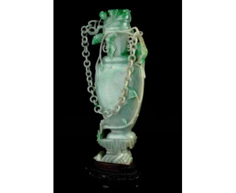 Age: late Qing dynasty    Description: A very fine Chinese sea-foam green jadeite "Grasshopper and Vine" vase, intricately wo