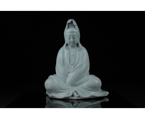 Qing dynasty   Description: A well-modeled figure of Guanyin smiling and seated with legs crossed, flowing robes and undergla
