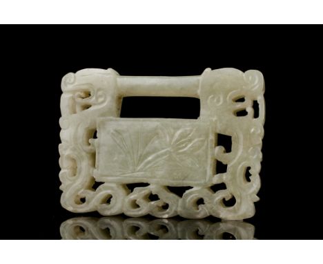 Age: Qing dynasty Description: A Chinese white jade Lock, carved with confronting stylized dragon heads over open scrollwork 