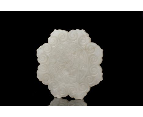 Age: Qing Dynasty  Description: A white jade plaque carved with a phoenix and bamboo design in a center roundel encircled wit