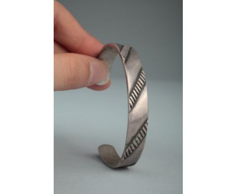 Age: Early 20th Century   Description: A scarce American Indian Navajo ingot silver band bracelet with filed and chiseled dec