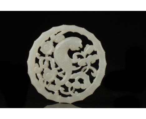 Date: Qing dynasty   Description: An attractive Chinese white jade circular pendant plaque, carved with a parrot in openwork 